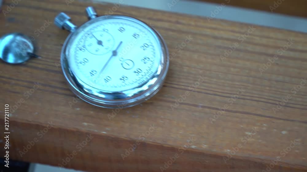 Stopwatch lies on bench, time shift concept Stopwatch lies on bench, time shift concept