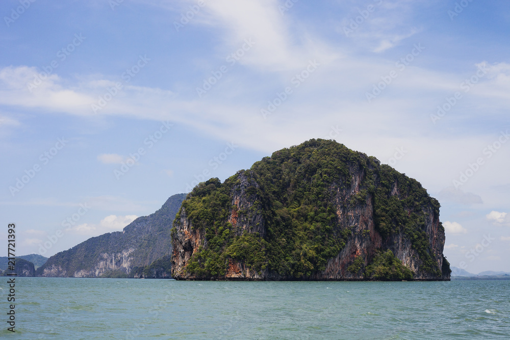 Seascape with green island against blue sky, Phuket, Thailand Seascape with green island against blue sky, Phuket, Thailand