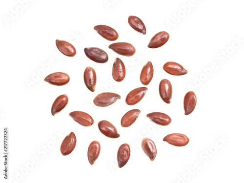 Some linseeds or flax seed spread out isolated on white background