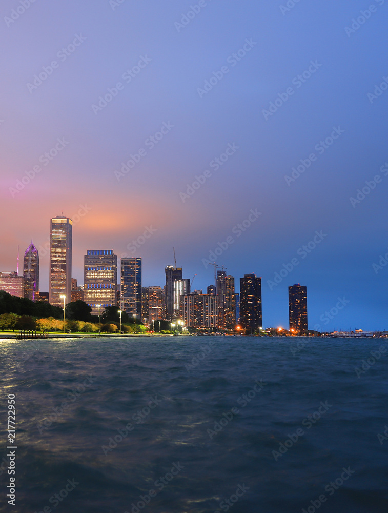 Chicago, Illinois, USA - June 22, 2018 - The Chicago skyline at night after a storm across Lake Michigan. Chicago, Illinois, USA - June 22, 2018 - The Chicago skyline at night after a storm across Lake Michigan.