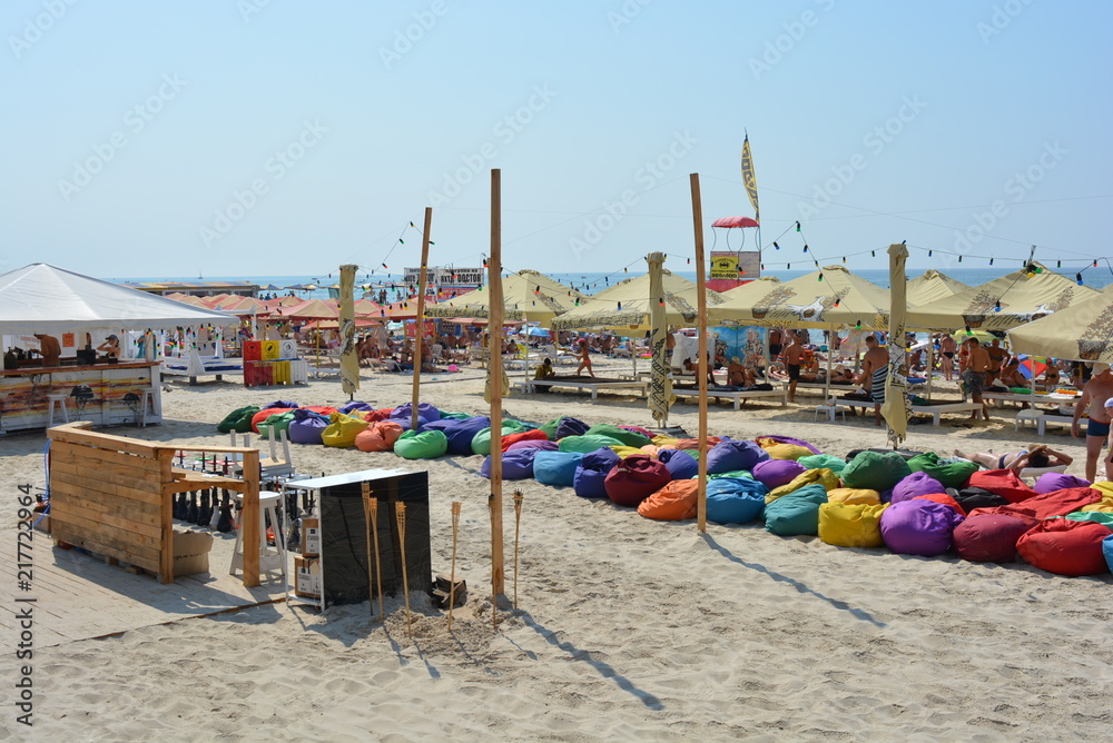 Summer beach of the Black Sea with outdoor cafes along the shore and places for summer relaxation and street entertainment