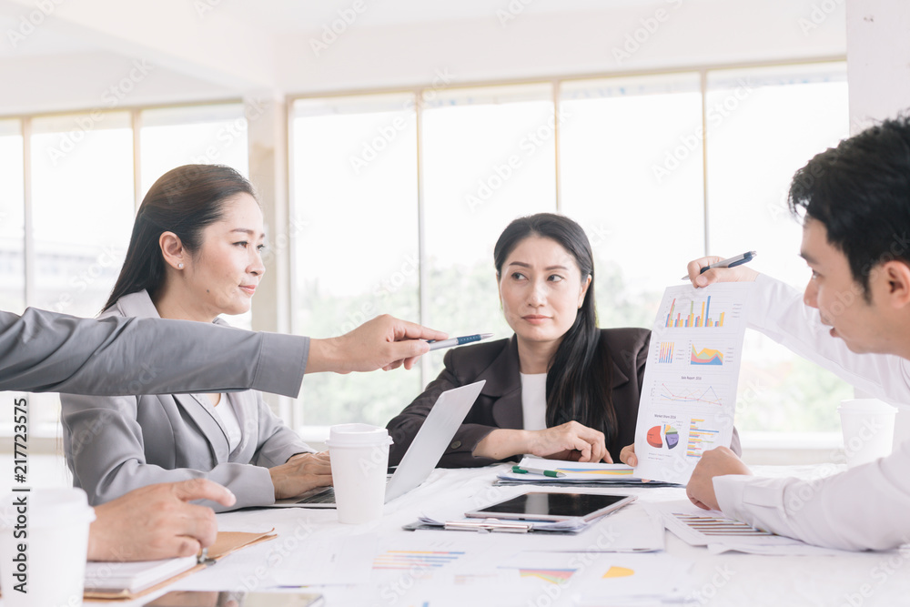 Businessmen gather at the talk show desk for interesting ideas in the office.