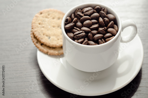 A cup of coffee with cookies