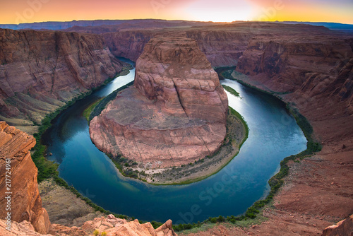 Horseshoe Bend is a beautiful horse-shoe-shaped water meander made by the Colorado River in Arizonian red rock desert landscape, close to Page, Arizona, USA. Scenic view from steep cliffs above