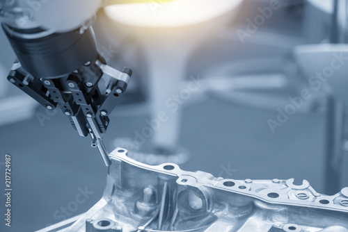 The robot for manufacturing the aluminum automotive part .The automotive part quality control concept.