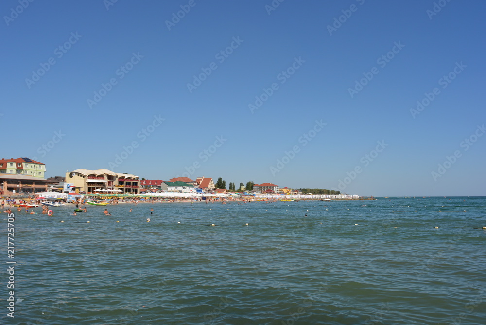 Beach with a tourist on the shore of the Black Sea, sea rest and relaxation