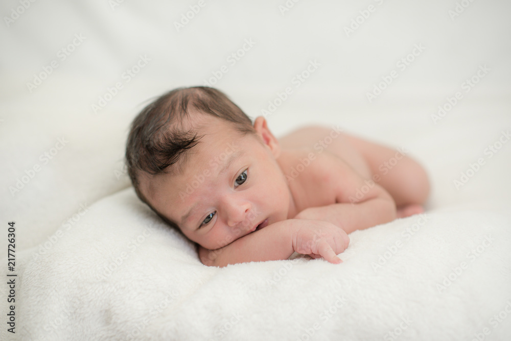Cute newborn baby on a blanket - happy family moments concept Cute newborn baby on a blanket - happy family moments concept