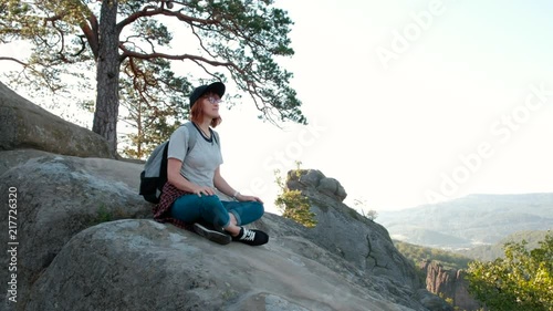 Girl hippest meditates in beautiful mountains, travel and relaxation photo