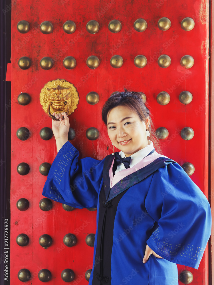 A Charming Asian Girl / Lady in The Blue, Chinese Style Academic Dress or Graduation Gown in A Public Park of CHINA.