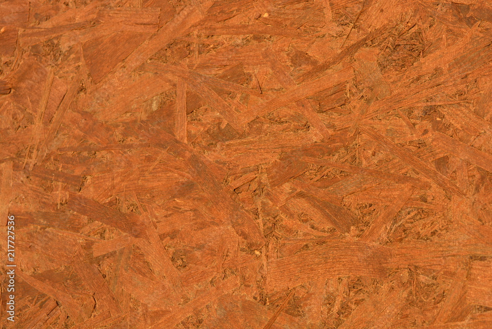 Construction oriented chipboard covered with brown varnish, original woody background-plate