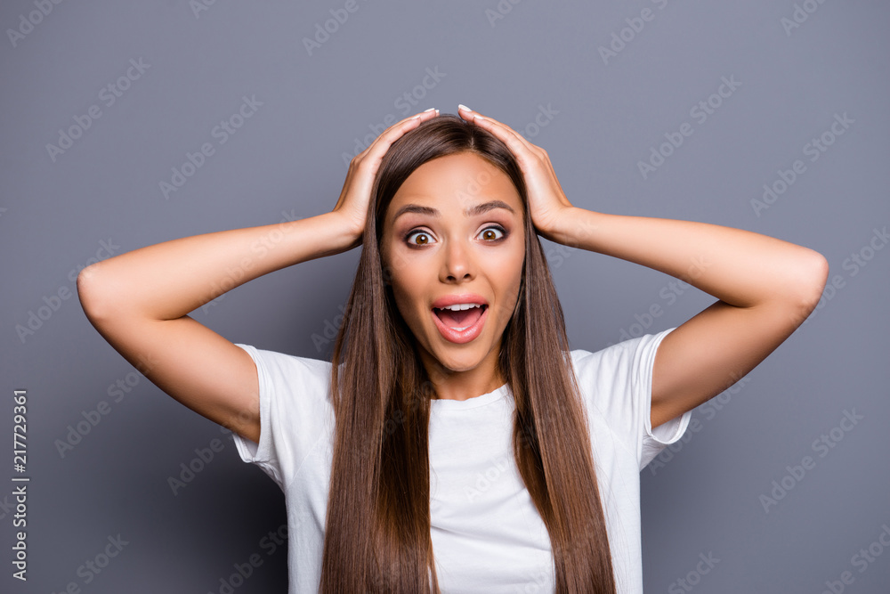TOTAL SALE! Close up portrait of extremely happy and amazed cheerful young woman touching her head isolated on grey background TOTAL SALE! Close up portrait of extremely happy and amazed cheerful young woman touching her head isolated on grey background