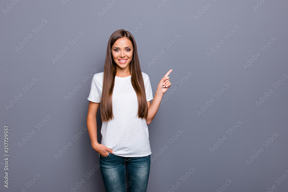 Attractive woman in a white tshirt pointing with her index finge Attractive woman in a white tshirt pointing with her index finge