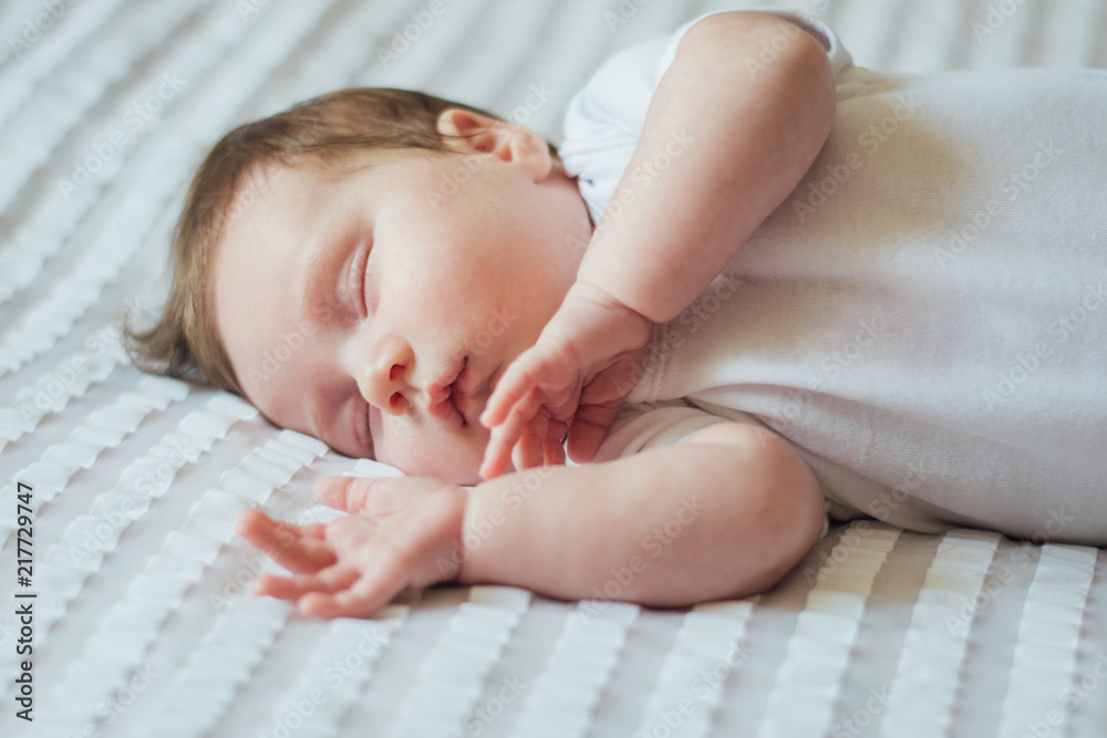Cute infant child sleeping on white sheets Cute infant child sleeping on white sheets