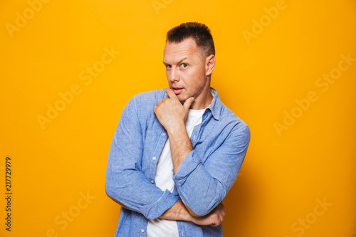 Portrait of a pensive middle aged man looking at camera