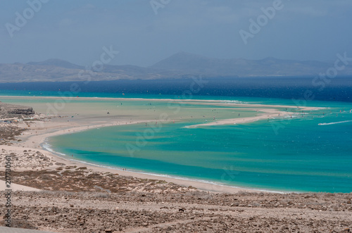 ocean landscape. blue ocean, sand beach with lagoon and watersport (kitesurfing and windsurfing)
