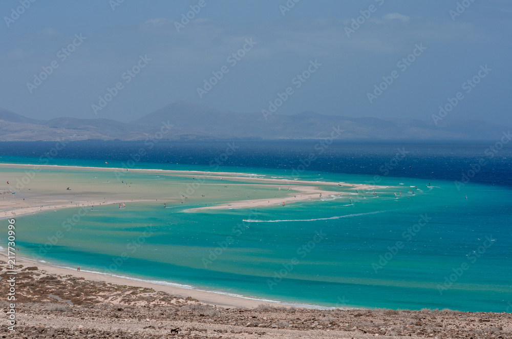 ocean landscape. blue ocean, sand beach with lagoon and watersport (kitesurfing and windsurfing)