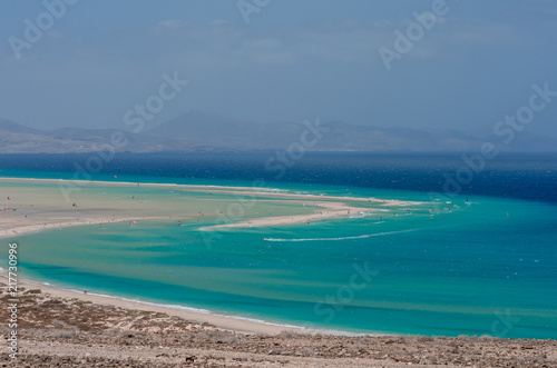 ocean landscape. blue ocean, sand beach with lagoon and watersport (kitesurfing and windsurfing)