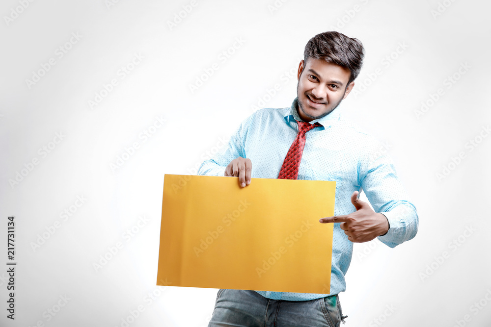 happy Young indian man showing blank poster happy Young indian man showing blank poster