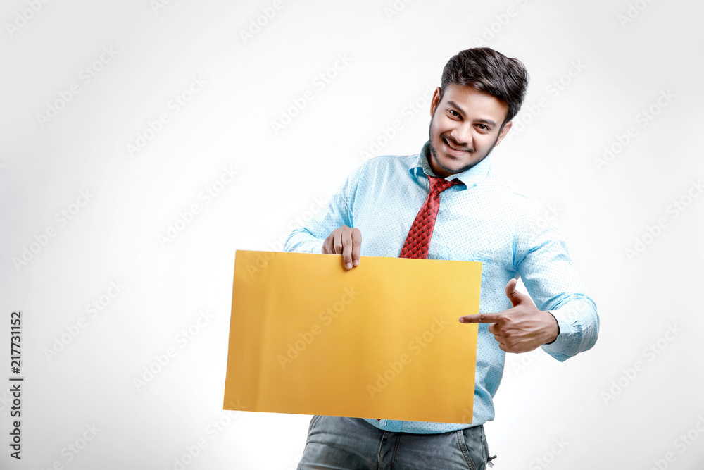 happy Young indian man showing blank poster happy Young indian man showing blank poster