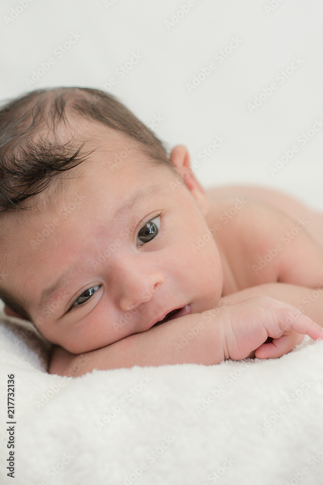 Cute newborn baby on a blanket - happy family moments concept Cute newborn baby on a blanket - happy family moments concept