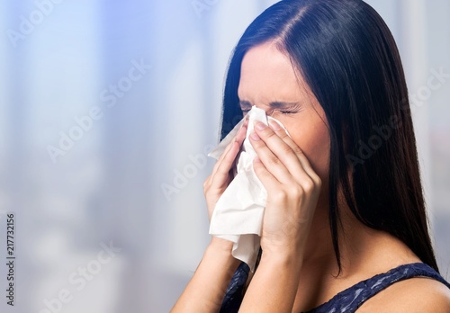 Young ill woman on blurred background