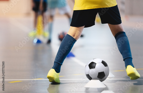 Indoor soccer players training with balls. Indoor soccer sports hall. Football futsal player, ball, futsal floor. Sports background. Futsal league. Indoor football players with classic soccer ball. © matimix