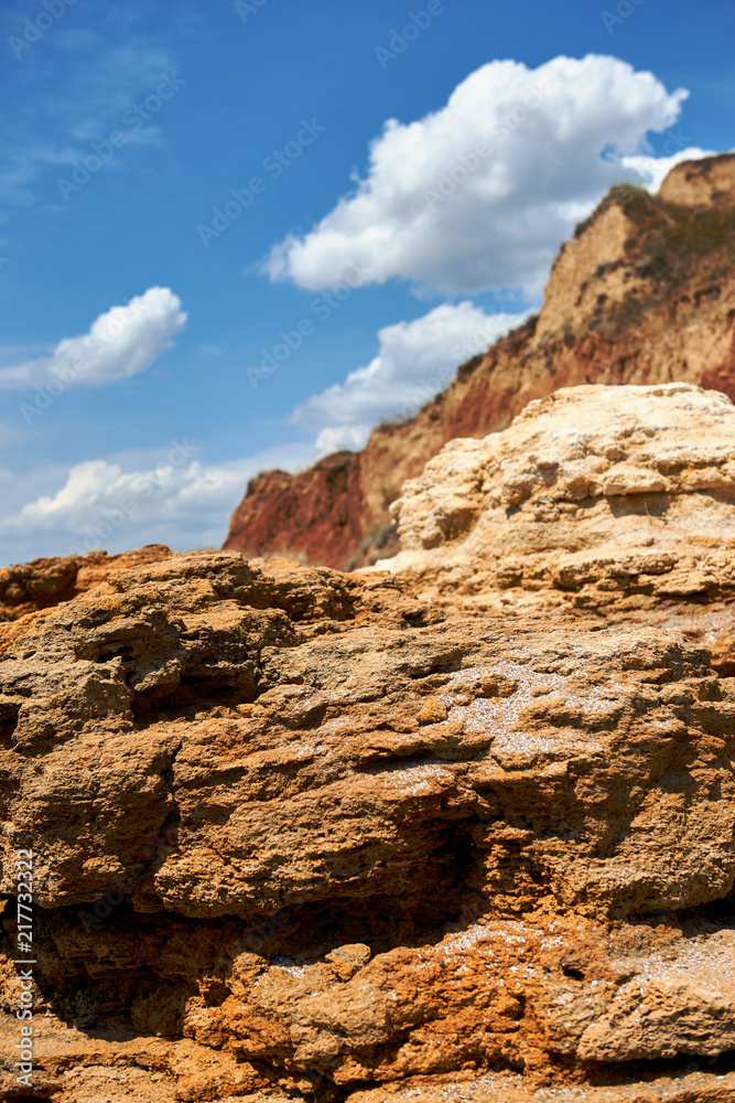 beautiful sea landscape, closeup of stone on the beach, sea coast with high hills, wild nature