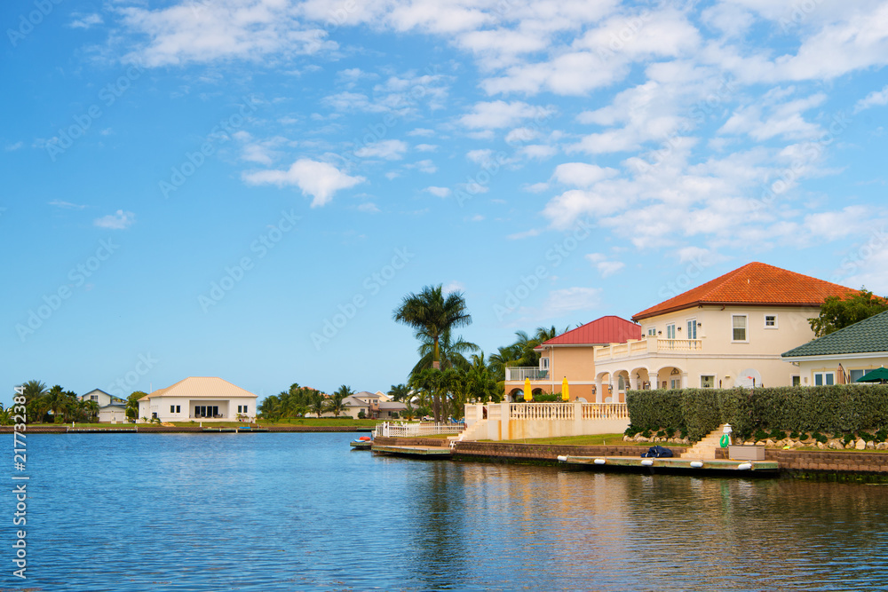 Obraz premium Summer villa of George Town, Cayman Islands. View on summer villa from sea. Summer villa houses on blue sky. Architecture of summer villa. vacation on caribbean