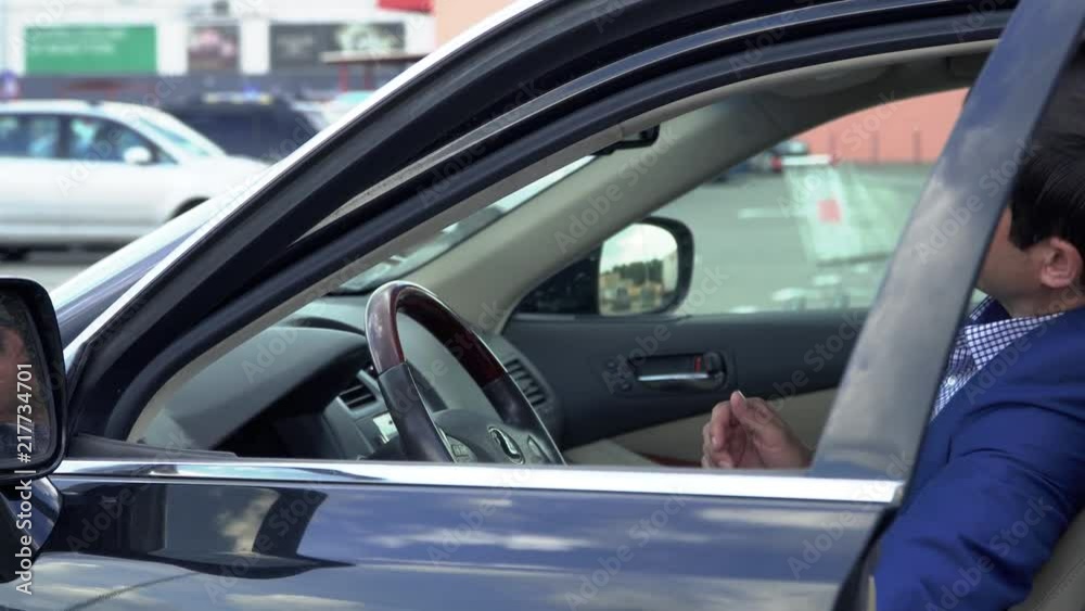 Successful businessman sits in an expensive car Successful businessman sits in an expensive car