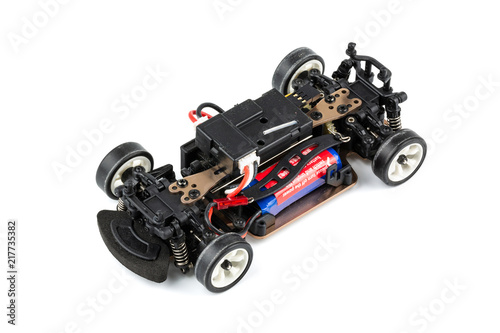 Macro shot of RC drift car (Radio-controlled) without body isolated on white background. (This toy has some dust from children playing)