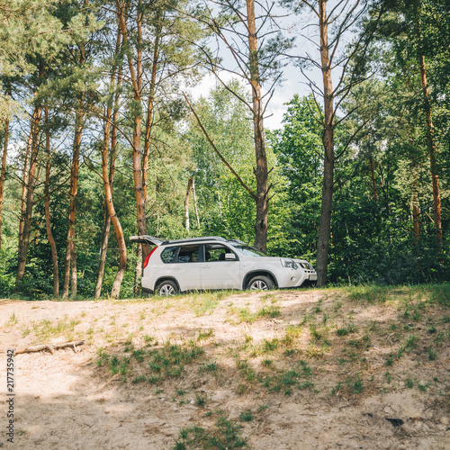 white suv in forest. car travel concept. lifestyle © phpetrunina14