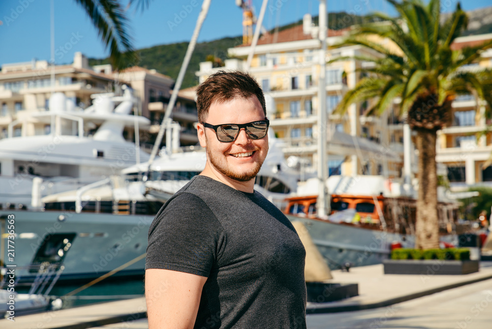 portrait of man yachts and dock on background