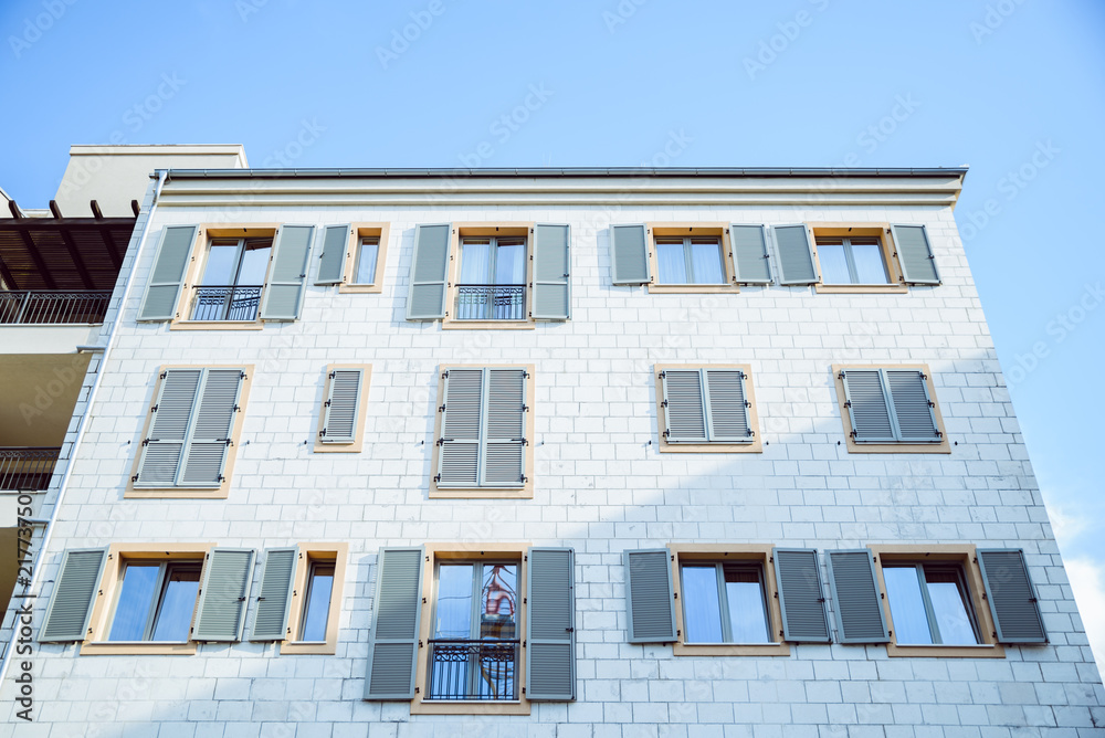 brick building with windows with shutters.