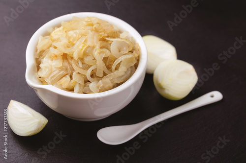 Homemade caramelized onions in frying pan. Vegetarian food.. photo