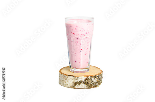 Glass of yoghurt cocktail, smoothies, with berry stands on a birch stump, isolated on white background.