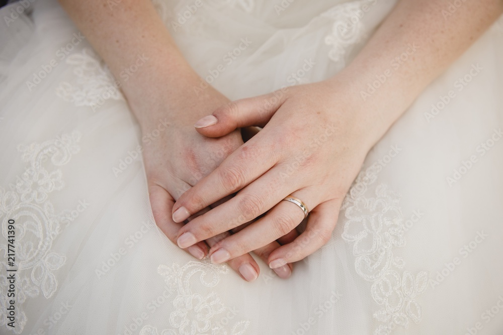 Detail of a white and elegant wedding dress. Detail of a white and elegant wedding dress.