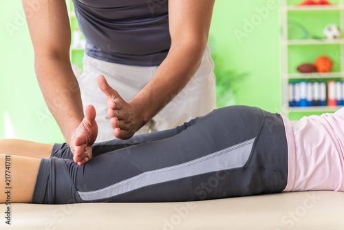 Young doctor chiropractor massaging patient 