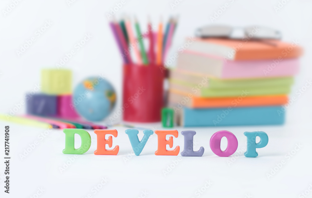 Obraz premium word develop on blurred background of school supplies .photo with copy space