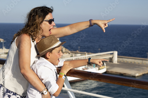 Mother and son pointing a place near the sea © Victor