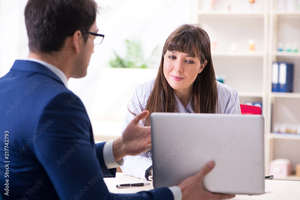 Businessman discussing health issues with doctor Businessman discussing health issues with doctor