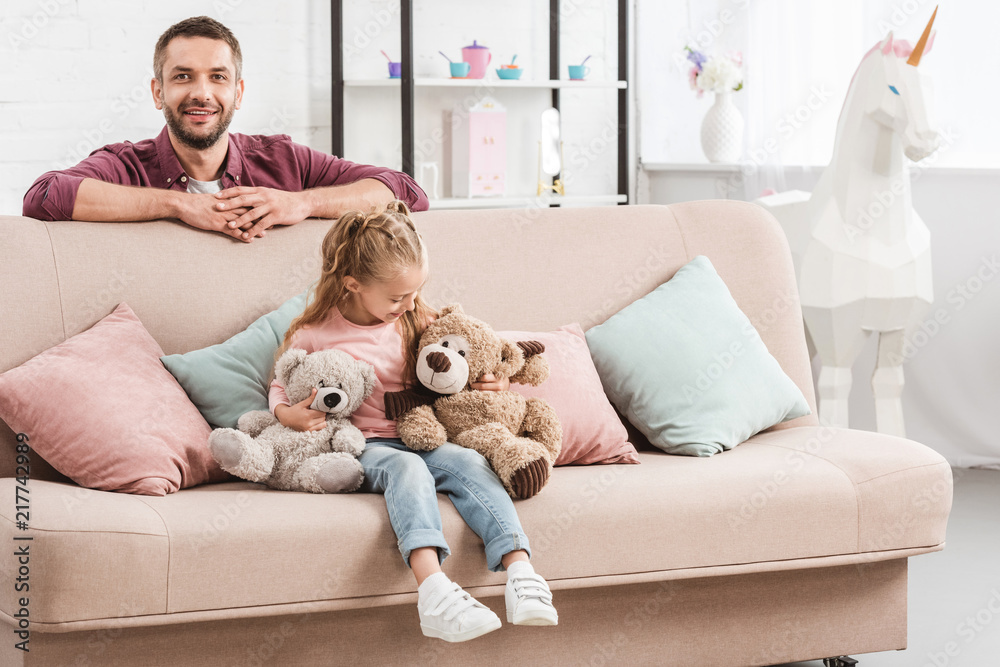 father and daughter having fun on sofa father and daughter having fun on sofa