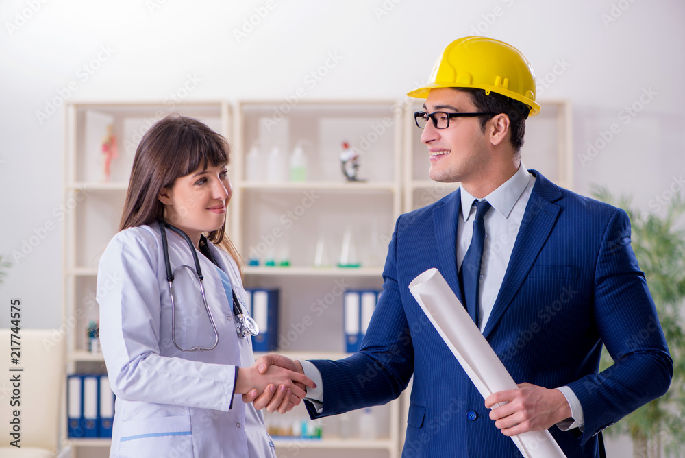 Doctor discussing new hospital plan with architect