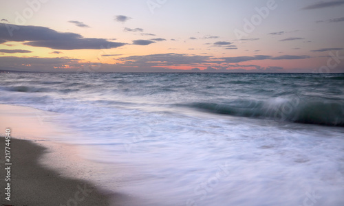 Seaside in sunset, sandy beach with waves in Platamon, Platamonas, Olympic region Greece