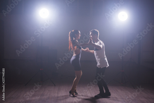 Active happy adults dancing bachata together in dance class