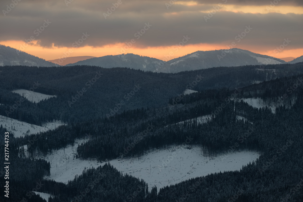 Winter landscape of a mountain range in winter. Sunset in the mountains.