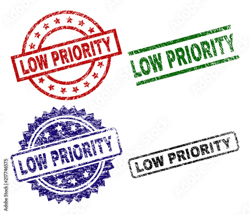 LOW PRIORITY seal prints with distress texture. Black, green,red,blue vector rubber prints of LOW PRIORITY label with scratched texture. Rubber seals with round, rectangle, rosette shapes.
