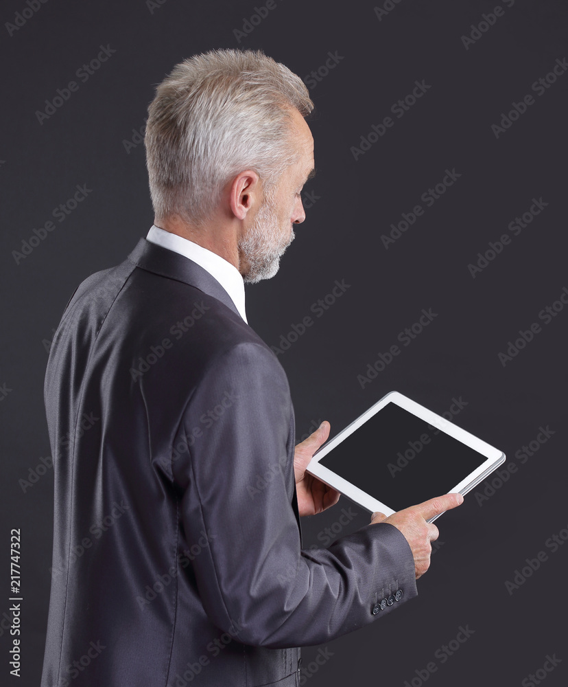 serious businessman looking at digital tablet screen serious businessman looking at digital tablet screen