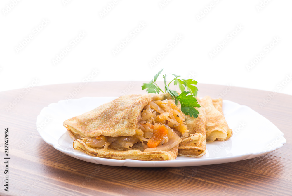 thin fried pancakes stuffed with stewed cabbage in a plate thin fried pancakes stuffed with stewed cabbage in a plate