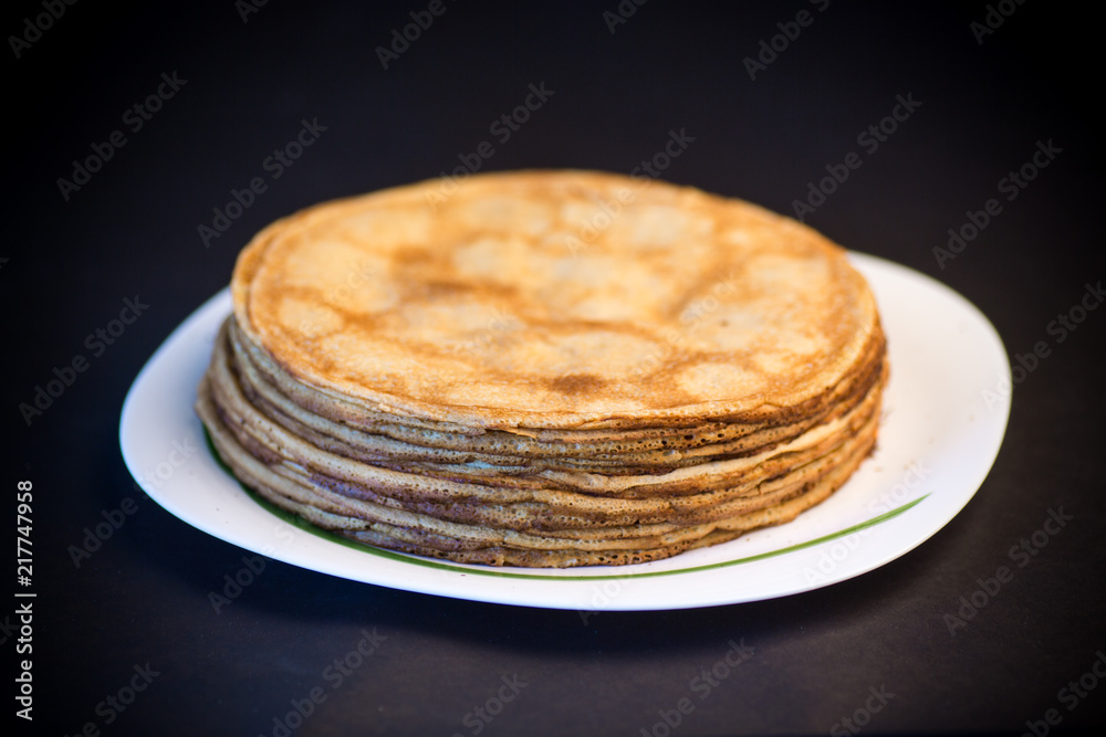 big high stack of thin pancakes in a plate big high stack of thin pancakes in a plate