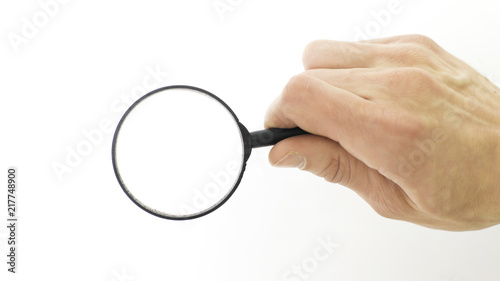 closeup.magnifier in the hand of businessman.